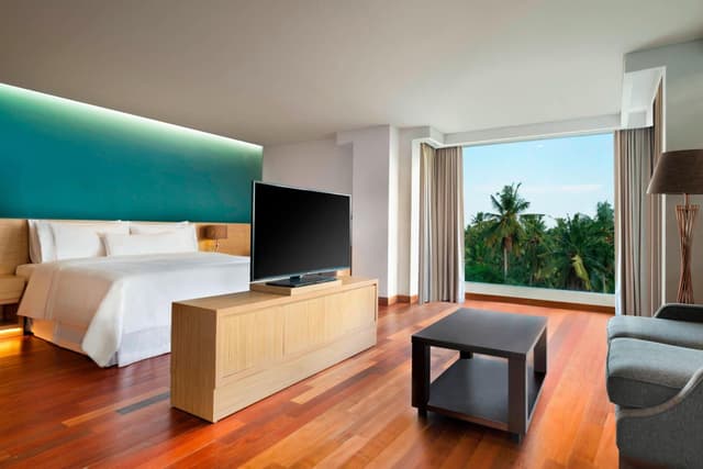 Punyan Suite Room, 1 Bedroom Suite, 1 King, Garden view, Balcony with Free Mini Bar, Daily Shuttle to Monkey Forest, Daily Yoga, Free Bike to borrow,  Free Family Activity and 24 Hour access to Motion Fitness Center